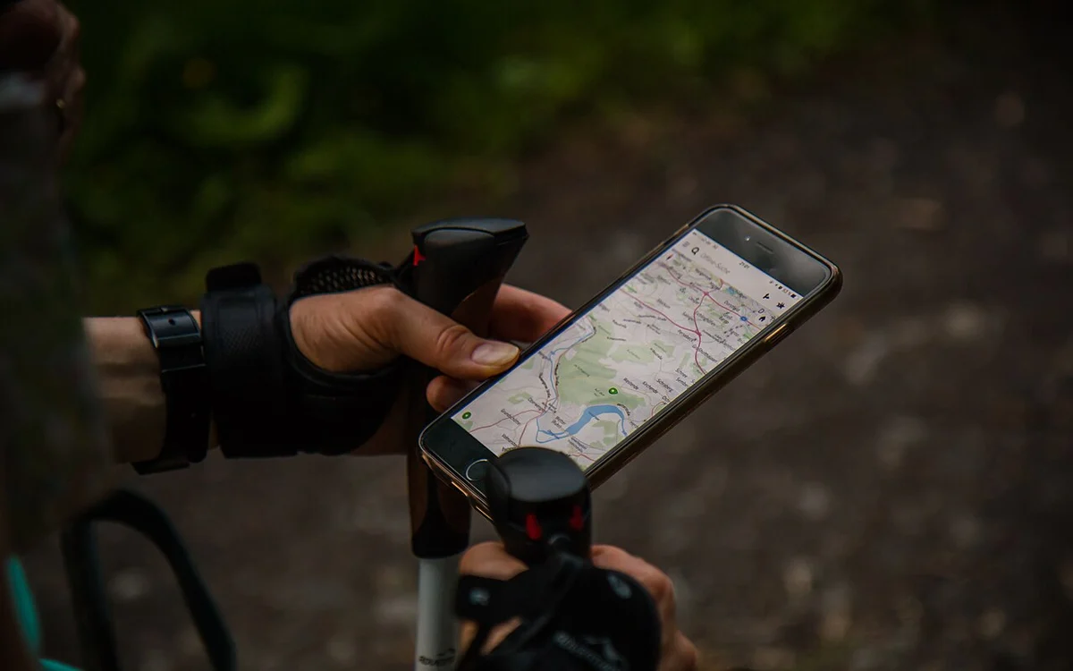 Illustrative photograph of smartphone use outdoors, for managing unwanted calls. Not a depicted spam call.
